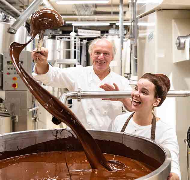 Personen rühren Schokolade in Fabrik.