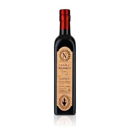Flasche Cavalli Balsamessig mit rotem Verschluss auf schwarzem Hintergrund.