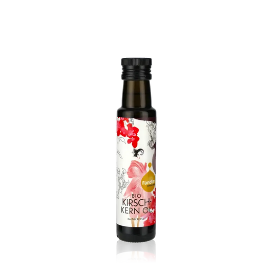 Fandler Bio Kirschkernöl Flasche auf schwarzem Hintergrund.