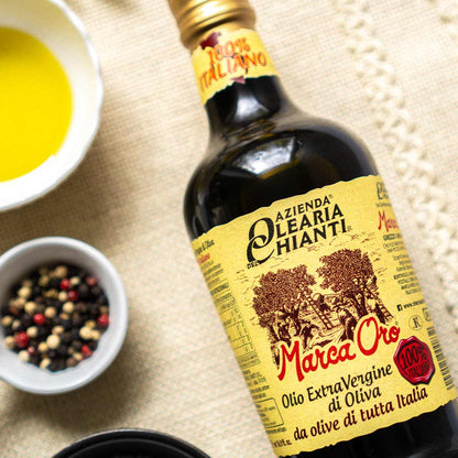 Flasche Olearia Chianti Olivenöl mit Schalen und Gewürzen.
