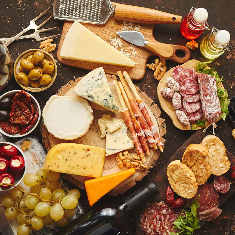 Käse, Wurst, Oliven, Wein, Essig, Öl, Brot, Trauben, Nüsse.