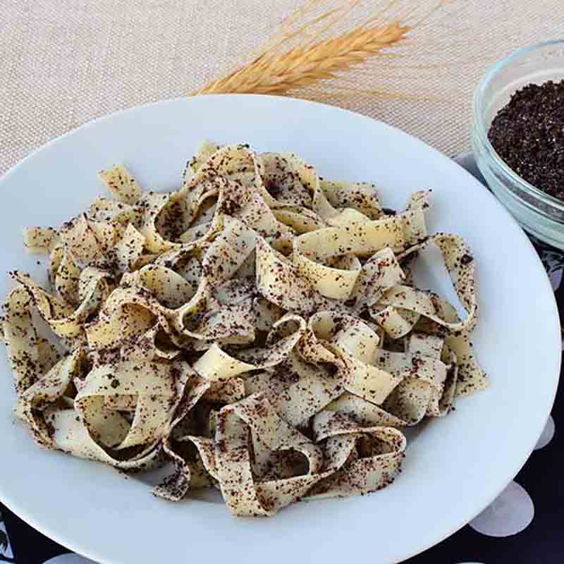 Pasta mit Mohnpesto auf weißem Teller, Nahaufnahme.